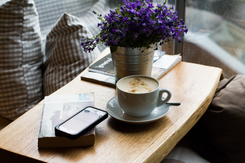 Smartphone and Book over Coffee Table Outside